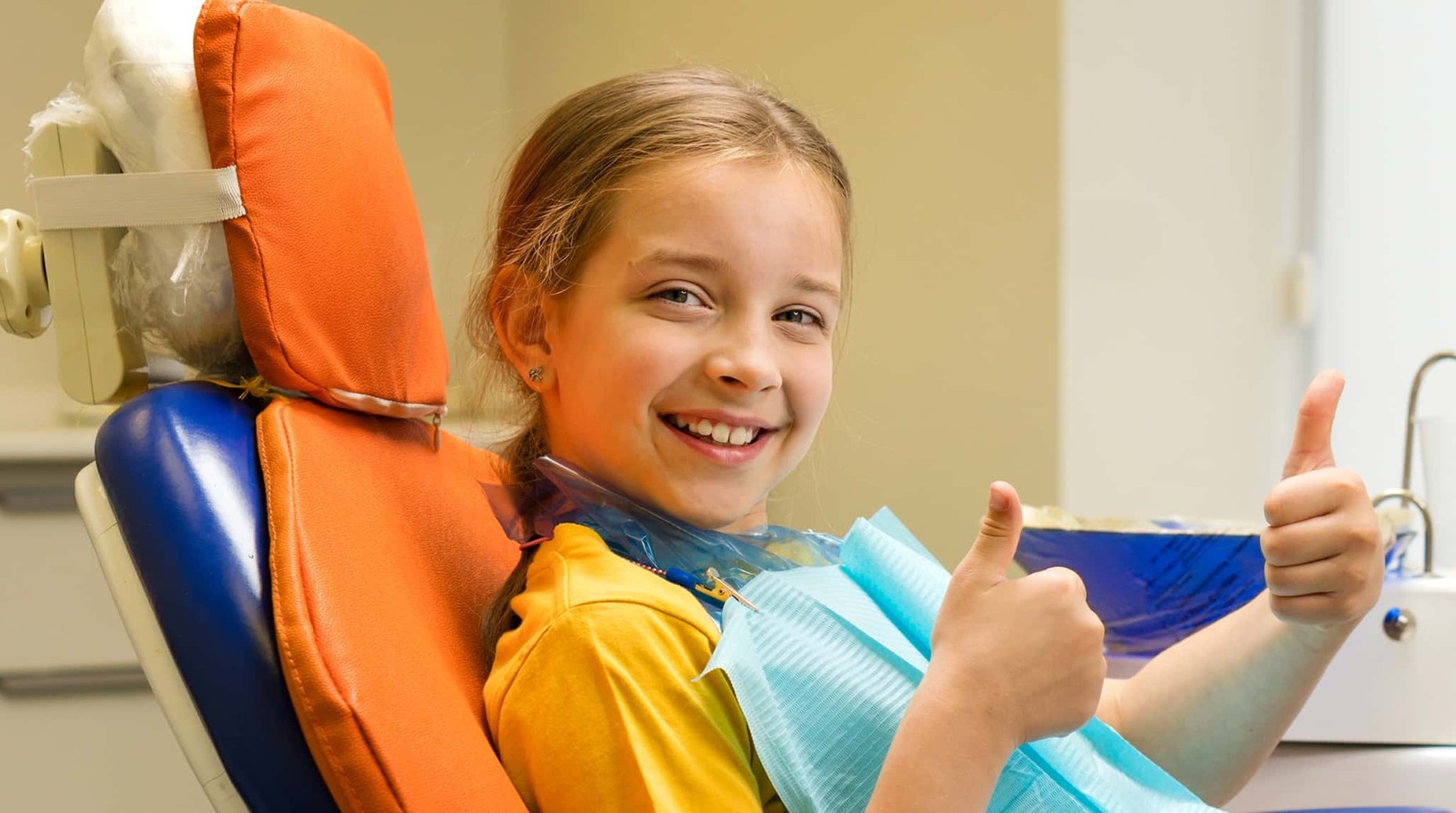 Employee receiving a routine dental cleaning from a hygienist