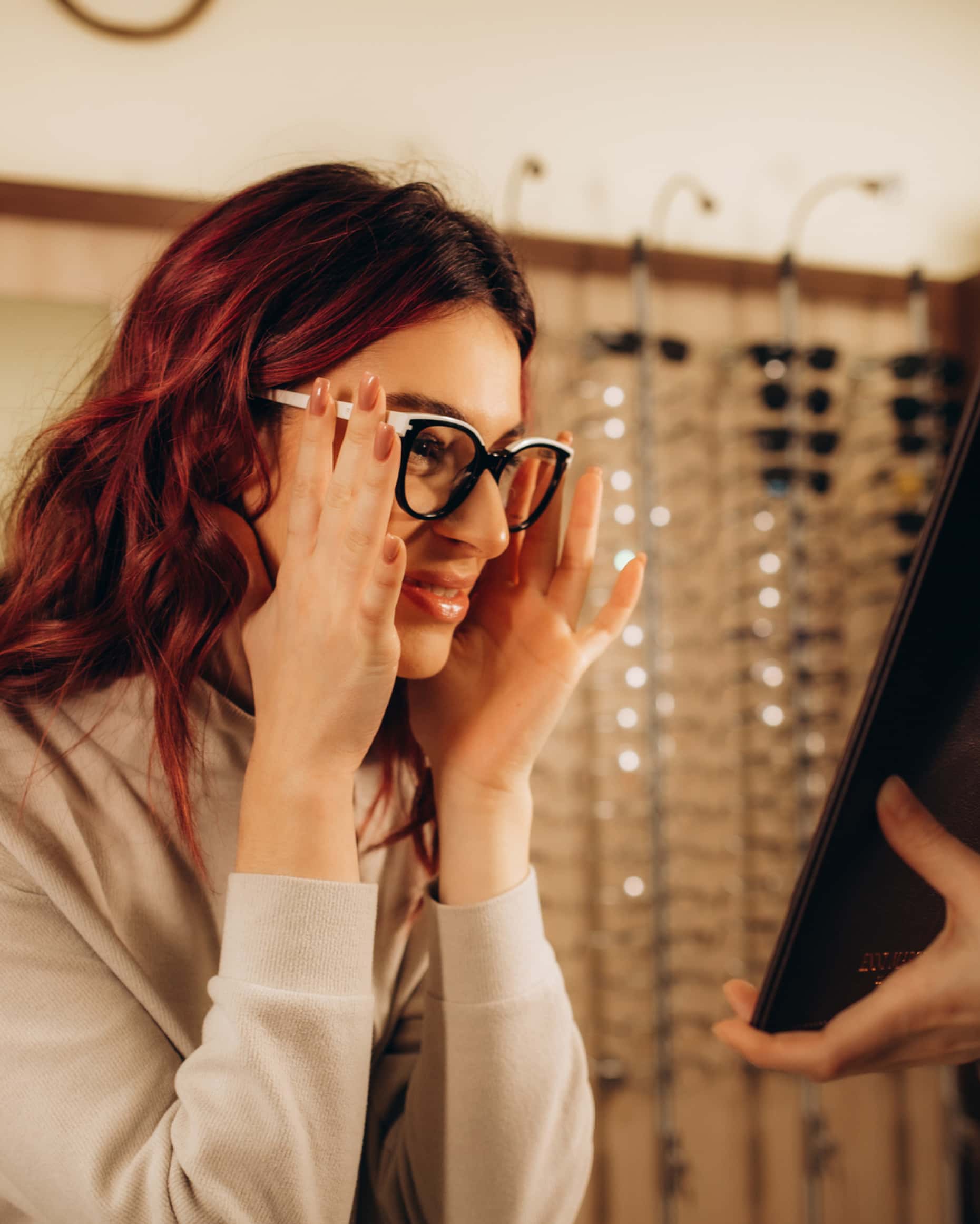 Optometrist showing a patient eyeglasses options during an eye exam
